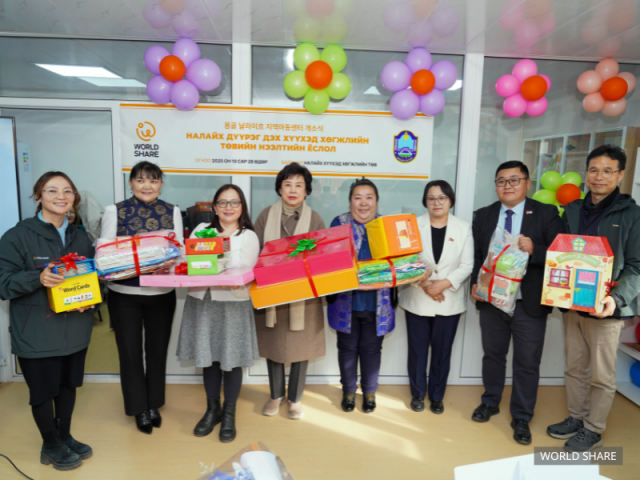 몽골 지역아동센터 개소식에서 아동 선물을 들고 기념 촬영을 하고 있다