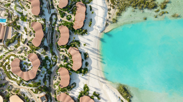 An aerial view of Four Seasons Resort and Residences at Shura Island, set along the shoreline with clear views of the Red Sea.