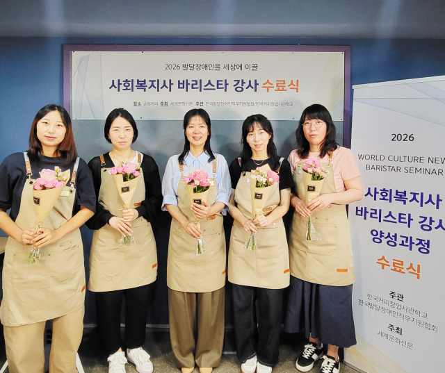 ‘2026년 발달장애인 바리스타 강사 양성과정’에 참여한 사회복지사들이 수료식 후 단체 기념 촬영을 하고 있다