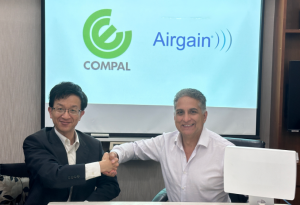 Yiyun Chang, Vice President at Compal Electronics, Inc. (left), shaking hands with Dr. Ali Sadri, CTO of Airgain, Inc., after signing a strategic MOU. (Photo: Business Wire)
