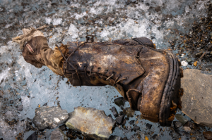 A sock embroidered with “A.C. Irvine”, along with a boot, has been discovered on the Central Rongbuk Glacier below the North Face of Mount Everest by a team led by Jimmy Chin. This is the first possible proof of Irvine's death since disappearing during a 1924 expedition. (credit: Jimmy Chin)