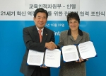 교육인적자원부의 김진표 장관과 인텔의 브렌다 무실리 교육 총괄이 양해각서를 교환하고 악수하는 장면