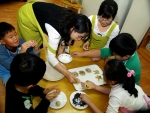 풀무원 봉사자와 ‘서대문 종합 사회 복지관’내 공부방 어린이들이 함께 두부 쿠키를 만들고 있다.