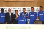 Left to right:  Michael Essien (defender) Peter Kenyon (Chief Executive Chelsea FC) Sang Heung Shin 