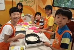지난 6.11일에 서울 양원초등학교에서 실시한 '찾아가는 쿠킹버스 방과후 교실'에서 참가 학생들이 직접 요리를 하고 있다.