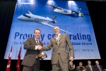 Ian McDougall, Chairman of the Canadian Air & Space Museum presents Simon Roberts, Vice President an