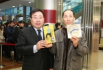 이승재 서울지방우정청장(왼쪽)이 서울중앙우체국에서 첫 번째로 ‘싸이, 나만의 우표’를 구입한 고객에게 싸이 친필이 담긴 아트카드와 흠뻑쇼 DVD를 증정하고 기념촬영을 하고 있다.