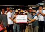 이상진 하나투어 CSR팀장(앞줄 왼쪽 두번째)과 김혜경 씨엠립 다일공동체 원장(앞줄 오른쪽 두번째)이 캄보디아 씨엠립 수상빈민촌 주민들을 위한 배 전달식을 진행했다.