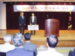 굿모닝보청기 금산센터 최성대 센터장이 대한노인회 금산센터에 귀걸이형 보청기 1대를 기증하고 있다.