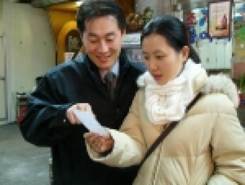 한 소비자가 신용카드로 음식값을 결재한 후 로또번호가 인쇄된 민들레영수증을 보고 신기해하는 모습.