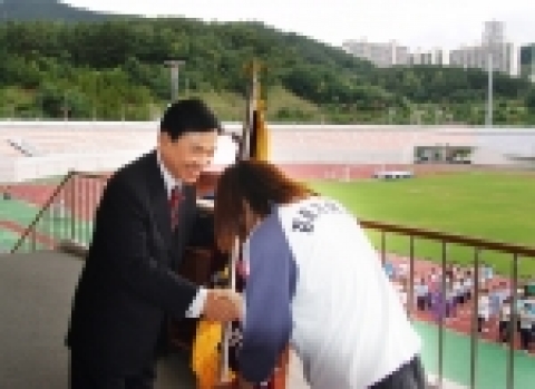 정경득 경상남도 육상경기연맹 회장이 대회기를 받고 있다