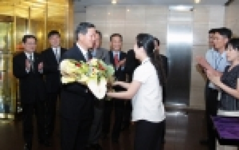 김규복 신보 이사장이 18일 마포 공덕동 신보 건물에 들어서며 직원으로부터 환영 꽃다발을 받고 환하게 웃고 있는 모습