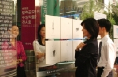 하나은행 본점 1층 로비에서 하나은행 고객들이 달력공모전 수상작을  감상하고 있는 모습임.