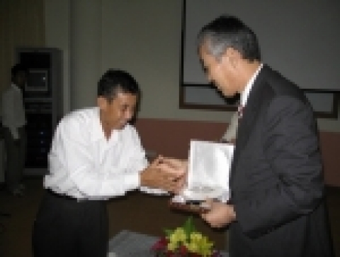 경상대학교 조무제 총장과 캄보디아기술대학교 총장이 협의를 마친 뒤 기념품을 전달하며 악수하고 있다.