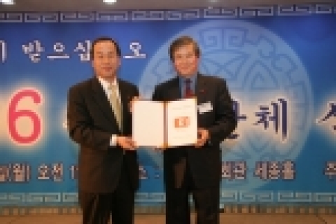 E1 영업본부장 최수종 상무(왼쪽)가 한국장총 김성재 상임대표에게 기금증서를 전달하고 있다.