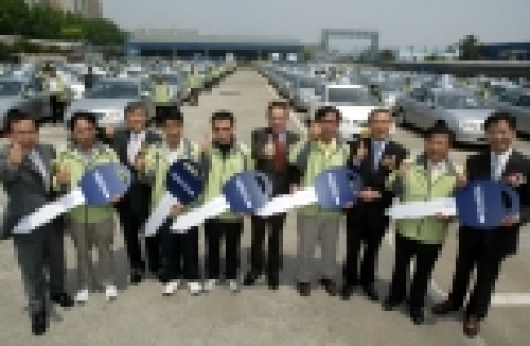 지난 24일 GM DAEWOO 부평공장에서 열린 토스카 개인택시 홍보대사 발대식에서 홍보대사들이 토스카 모형 열쇠를 받아들고 파이팅을 외치고 있다. 사진 오른쪽에서 다섯번째가 GM