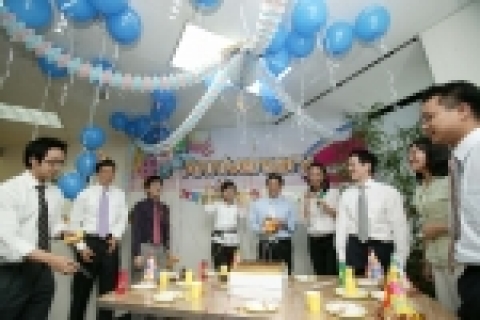 르노삼성자동차 직원들이 사무실을 예쁜 꽃장식과 풍선으로 꾸미고 기념케익을 자르며 창립 6주년을 자축하고 있다.