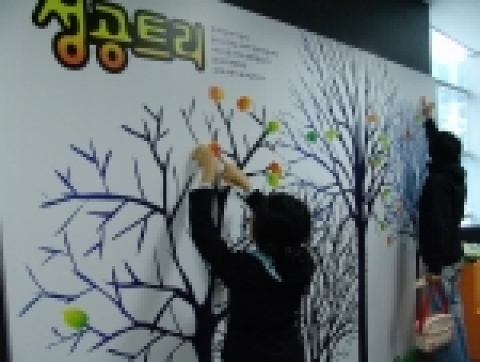 성공취업을 기원하는 메시지를 '성공트리'에 붙이고 있다.