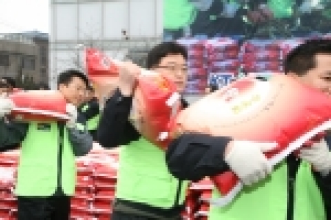 KT사랑의 봉사단원들이 사랑의 쌀을  나르고 있는 모습 