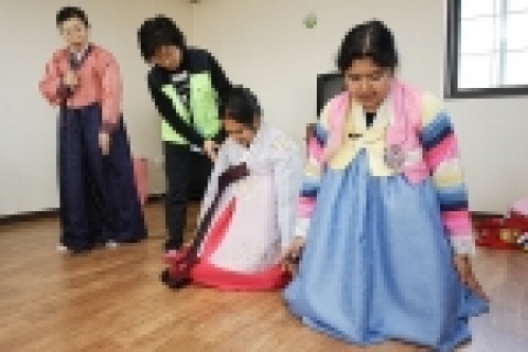 외국인 아이들에게 세배하는 법을 가르쳐 주고 있는 모습