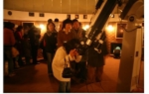 천문대에서 천체망원경으로 토성을 보는 가족들