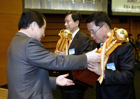 염홍철 중기특위 위원장이 조규상 두산엔진㈜ 대표이사에게 단체부문 싱글PPM 우수모기업상인 대통령 표창을 수여하고 있다.