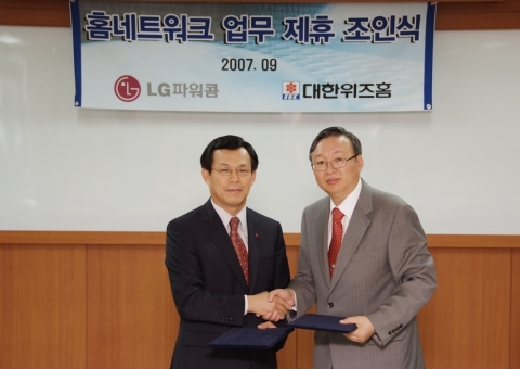 LG파워콤 법인사업담당 김종천 상무(왼쪽)와 대한위즈홈 영업본부장 홍진선 상무가 홈네트워크 사업 협력을 위한 업무제휴를 체결하고 악수를 나누고 있다.