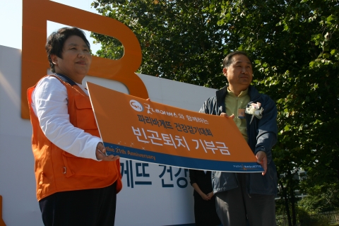 서울 남산 공원에서 열린 파리바게뜨 건강걷기 대회에서 파리바게뜨 김용관 전무가 굿네이버스 정금선 부회장에게 이 날 걷기대회 참가비 등 빈곤아동지원기금을 전달하고 있다. 