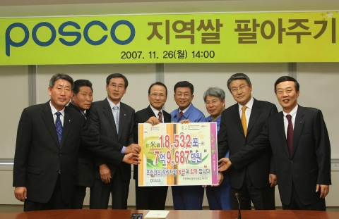 오창관 포항제철소장(우측에서 네번째)이 포항농협 이종형 조합장(우측에서 다섯번째)으로부터 ‘지역 쌀 구매내역 패널’을  전달받고 있다.