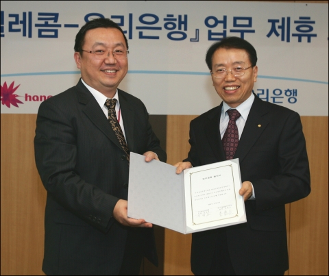 하나로텔레콤 이태규 상무(사진 좌), 우리은행 신상호 부장(사진 우)이 조인식에 참가해 기념 촬영을 하고 있다.
