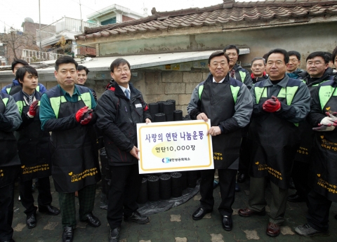 김상열 대한상공회의소 상근부회장(기증서 오른쪽)이 18일 동작구 동작동에서 이동섭 (사)따뜻한 한반도 사랑의 연탄나눔운동 상임이사에게 연탄 1만장 기증서를 전달하고 있다.