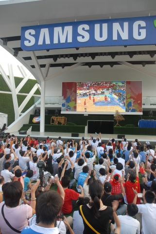 삼성올림픽홍보관 야외무대서 중계해주는 축구를 보며 관람객들이 하나되어 응원전을 하고 있다.