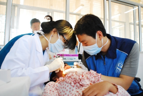 신한은행과  서울대 치과병원 의사들이 캄보디아 주민들에게 구순구개열 수술을 시술하는 모습.