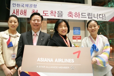 인천국제공항 여객터미널 입국도착장에서 아시아나항공 인천국제공항 박찬만 지점장(왼쪽에서 두번째)이 기축년 새해 첫 입국승객인 정영희씨(왼쪽에서 세번째) 및 아시아나 직원들과 기념촬영