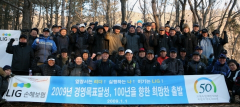 1일 새벽, 광교산 형제봉에서 해돋이를 관람한 LIG손해보험 임직원들이 2009년 경영목표 달성과 더불어 창립 50주년 맞이 비전을 공유하는 기념 행사를 가졌다. 1열 좌측부터 홍보담당 박주천 이사, 호남본부장 이홍수 이사, 영업총괄 장남식 사장, 대표이사 김우진 사장, 고객지원담당 윤성호 상무, 지원총괄 김병헌 부사장, 일반보험담당 김강현 이사, 신채널본부장 배규룡 담당.