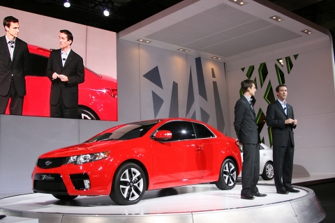 Tom Kearns, Chief Designer, Kia Design Centre America (left), and Michael Sprague, Vice President of Marketing, Kia Motors America (right), reveal Kia Forte Koup at the New York International Auto Show.