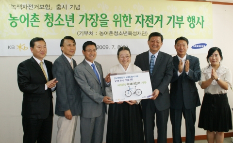 박청수 농어촌청소년육성재단 이사장, 심부환 KB 국민은행 부행장, 고영창 삼성화재 전무 등이  농어촌 청소년가장을 위한 자전거 전달식에 참석해 기념촬영을 하고 있다.