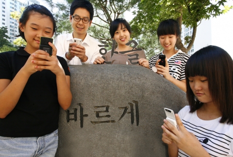 휴대폰 이용자들이 문자메시지를 보내는 모습.