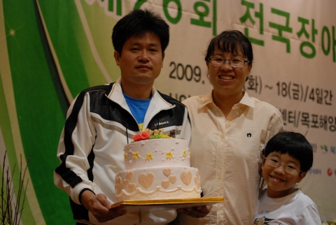 목포 신안비치호텔에서 열린 제6회 장애인기능대회 제과제빵부문에서 금메달을 수상한 광주지역 대표 이용규선수와 그의 가족들이 우승 작품을 들고 포즈를 취하고 있다.