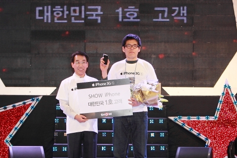 KT 김우식사장(사진 왼쪽)과 대한민국 1호 아이폰 개통 고객(허진석)이 쇼 아이폰 개통 행사장에서 기념 촬영을 하고 있다.