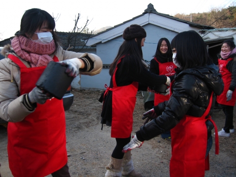 네이트 러닝메이트 대학생 멘토와 고3멘티들이 사랑의 연탄나눔 운동에 참여하여 연탄을 나르고 있다.