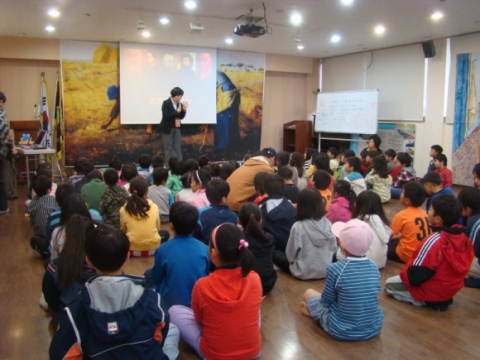 어린이들이 전시작품들을 감상하기전에 명화감상법 강의를 듣고있다