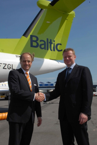 Kevin Smith, Senior Vice President, Sales (Interim) of Bombardier Commercial Aircraft (left) congratulates Air Baltic Corp President and CEO, Bertolt Flick at the Bombardier Q400 NextGen aircraft display at the 2010 Singapore Airshow.  The aircraft, presented in airBaltic colors, will conduct a demonstration tour in several Asia-Pacific countries following its appearance at the Singapore show