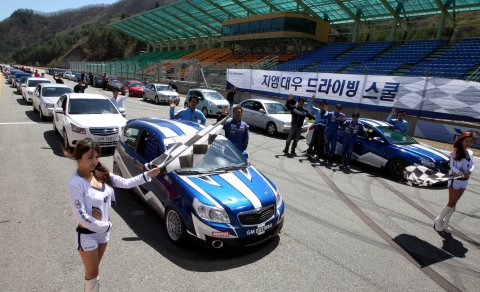 7일 강원도 태백 레이싱 파크에서 열린 GM DAEWOO '드라이빙 스쿨'에 참여한 일반인과 온라인 동호회 및 블로거 참가자들이 레이싱카 시승 전에 손을 흔들며 환호하고 있다. 이번 드라이빙 스쿨에서 참가자들은 GM DAEWOO 레이싱 팀 선수들로부터 직접 다양한 운전 기술, 가속 및 코너링 요령, 브레이크 사용법 등 운전 중 여러 상황에 대한 대처 방법 등을 교육받았다.