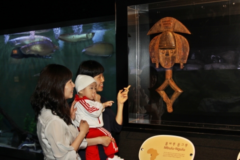 부산아쿠아리움에 전시된 아프리카 유물 ‘움브루응그루(Mbulu-Ngulu)’를 관람객이 신기한 듯 바라보고 있다. 이 작품은 아프리카 가봉 코타부족의 가면으로, 약 4천 만원을 호