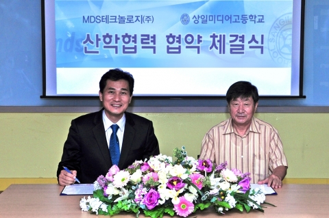 상일미디어고등학교 박용선 교장(오른쪽)과 MDS테크놀로지 오형관 상무(왼쪽)가 산학협력을 위한 협약서에 서명을 하고 있다