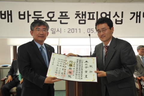 2011 olleh배 바둑 오픈 챔피언십 개막식에서 한국기원 양재호 사무총장(오른쪽)이 KT GSS부문 전인성 부사장(왼쪽)에게 아마 5단증을 수여하고 있다.