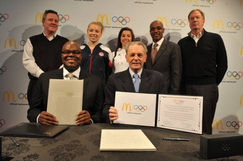 Don Thompson, McDonald‘s President and Chief Operating Officer Dr. Jacques Rogge (first right to left) International Olympic Committee President, Scott Blackmun, United States Olympic Committee Chief Executive Officer, Sarah Warren, member of the US Youth Olympic team, Nina Prock, member of the Austrian Olympic team, Kevin Newell, McDonald’s Executive Vice President and Global Chief Brand Officer and Larry Probst, USOC Chairman, back row from left to right, present the signed McDonald‘s Sponsorship renewal contract in Innsbruck, Austria on Friday, Jan. 13, 2012. McDonald’s and the IOC announced the renewal of McDonald&#039;s TOP Sponsorship through the 2020 Olympic Games.