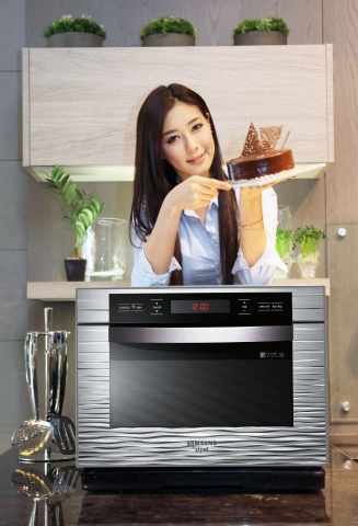 삼성전자가 스마트폰의 어플리케이션을 활용해 식재료 준비와 요리를 한 번에 끝낼 수 있는 지펠 스마트 오븐을 출시했다. 사진은 논현동 삼성 솔루션 전시장에서 삼성전자 모델이 신제품 오븐을 선보이는 모습.