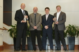 Micron and Intel executives accept the 2011 Semiconductor of the Year award for 20nm NAND. Pictured left to right: Glen Hawk, Micron; Harry Page, UBM; Joel Martin, UBM; Rob Crooke, Intel.